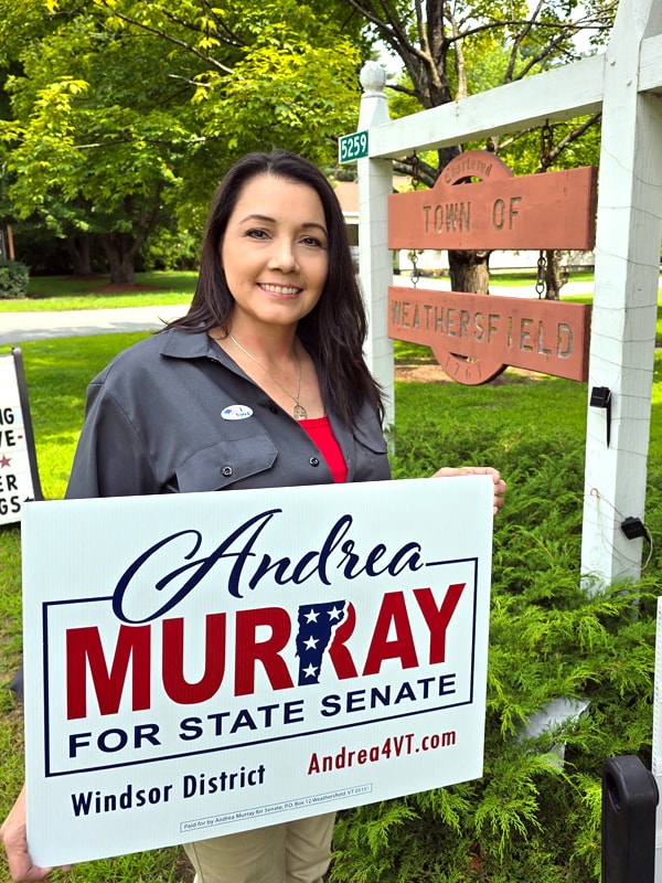 Andrea Murray supporters holding campaign signs at a community event