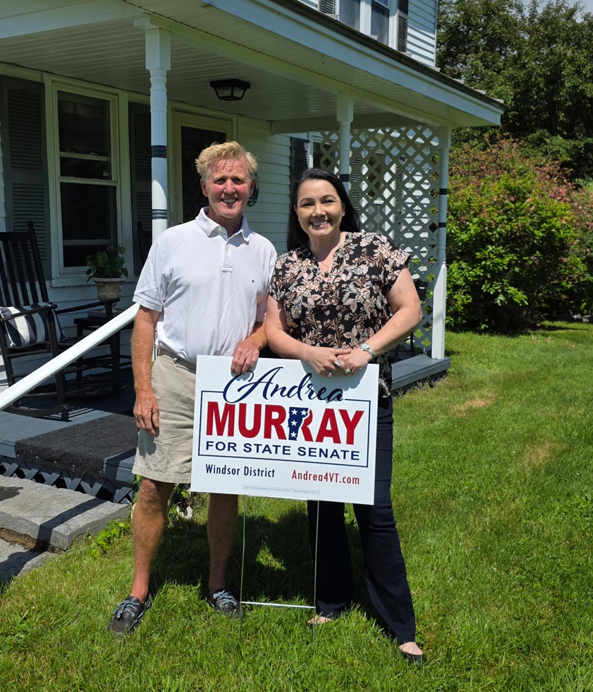 Andrea Murray with a supporter holding a yard sign in Hartford